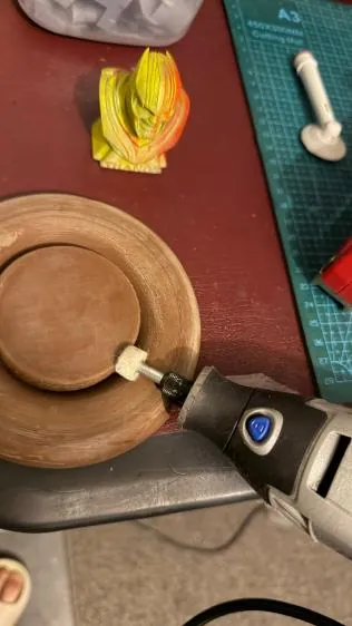 Sanding the base with a rotary tool
