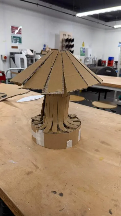 Cardboard model seen from a lower angle showing the thick stem and base