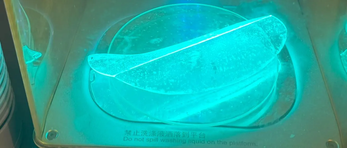 Clear resin print glowing under UV light