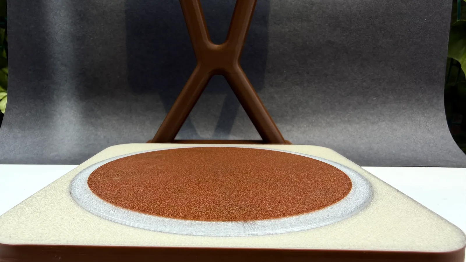 Close-up of the base: cream shell, translucent ring and terracotta coaster