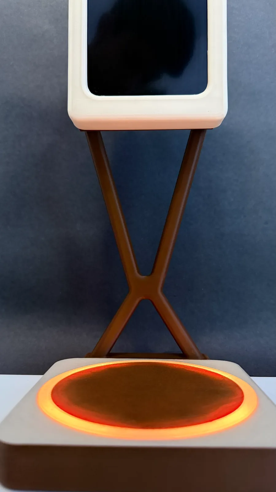 The base glowing orange through the PETG ring, below the screen
