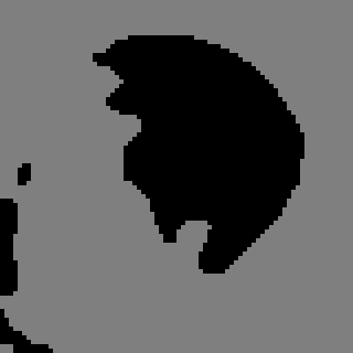 A grey and black thresholded image with a large black blob where the piece sits