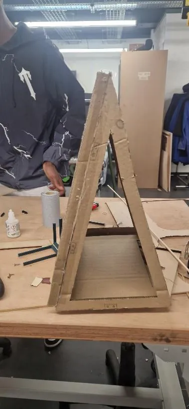 Side view of cardboard model V2 with a broader, stable base